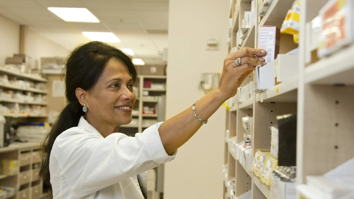 薬局で棚から薬を取る薬剤師
